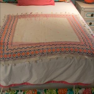 neon pink and blue patterned scarf with tassels